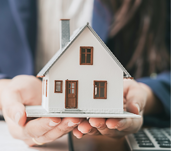 image of hands holding up a model house